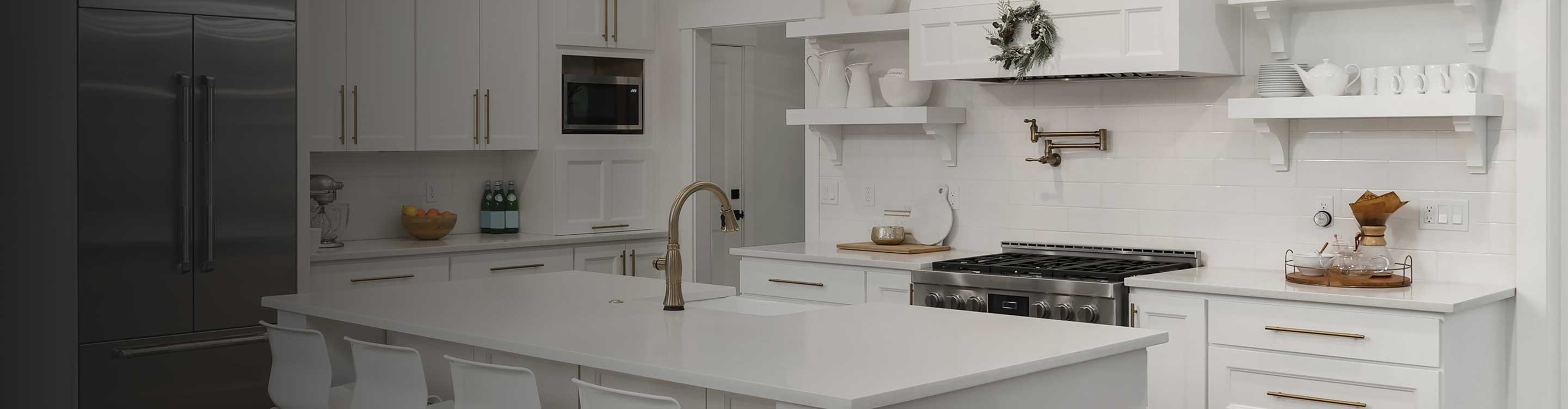 White tile backsplash in a kitchen with white countertops and cabinetry